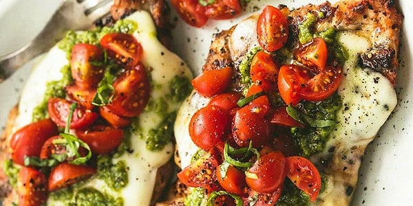 Baked Caprese Chicken Pesto with Cherry Tomatoes and Mozzarella Cheese