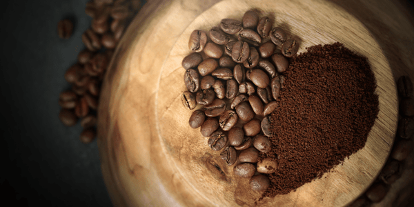 Coffee heart divided into ground coffee and coffee beans for lovers of good coffee. Dark bacground.